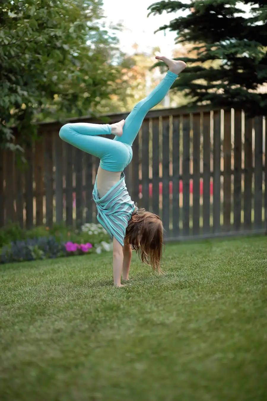 A handstand coach mid-balance
