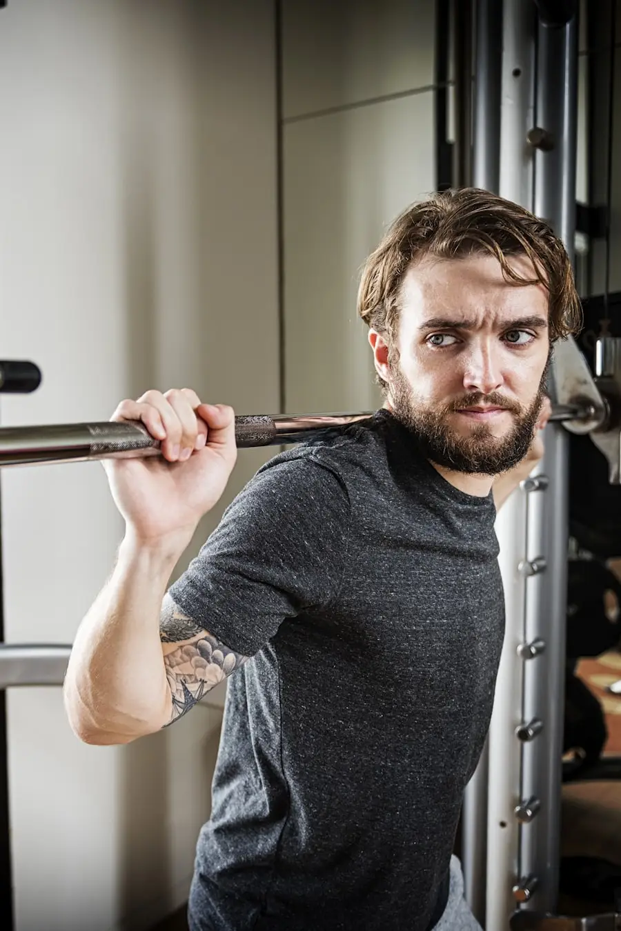 A strength coach at a squat rack